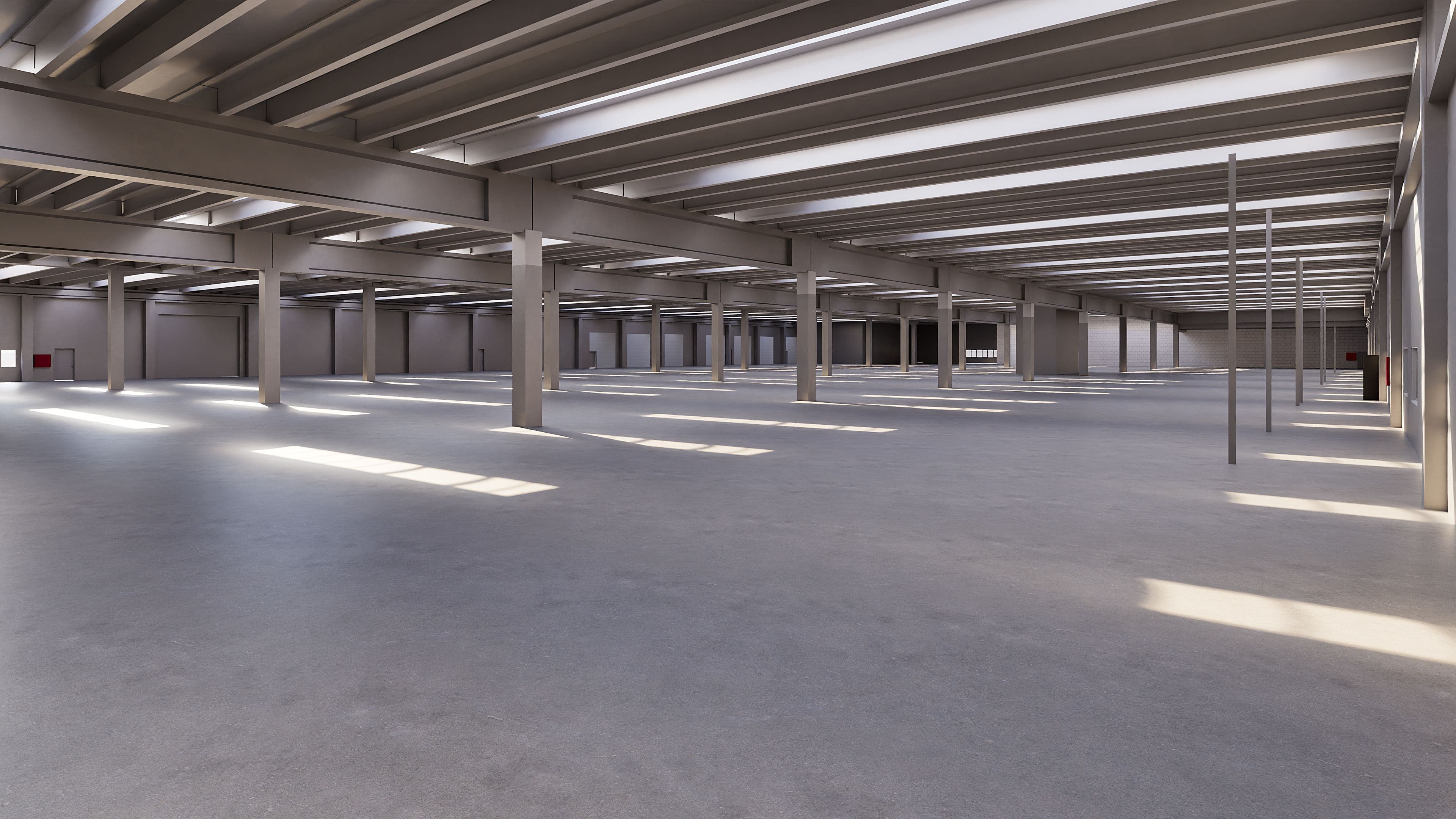 Weiträumige, leere industrielle Lagerhalle mit sichtbaren Stahlträgern und natürlichem Lichteinfall.
