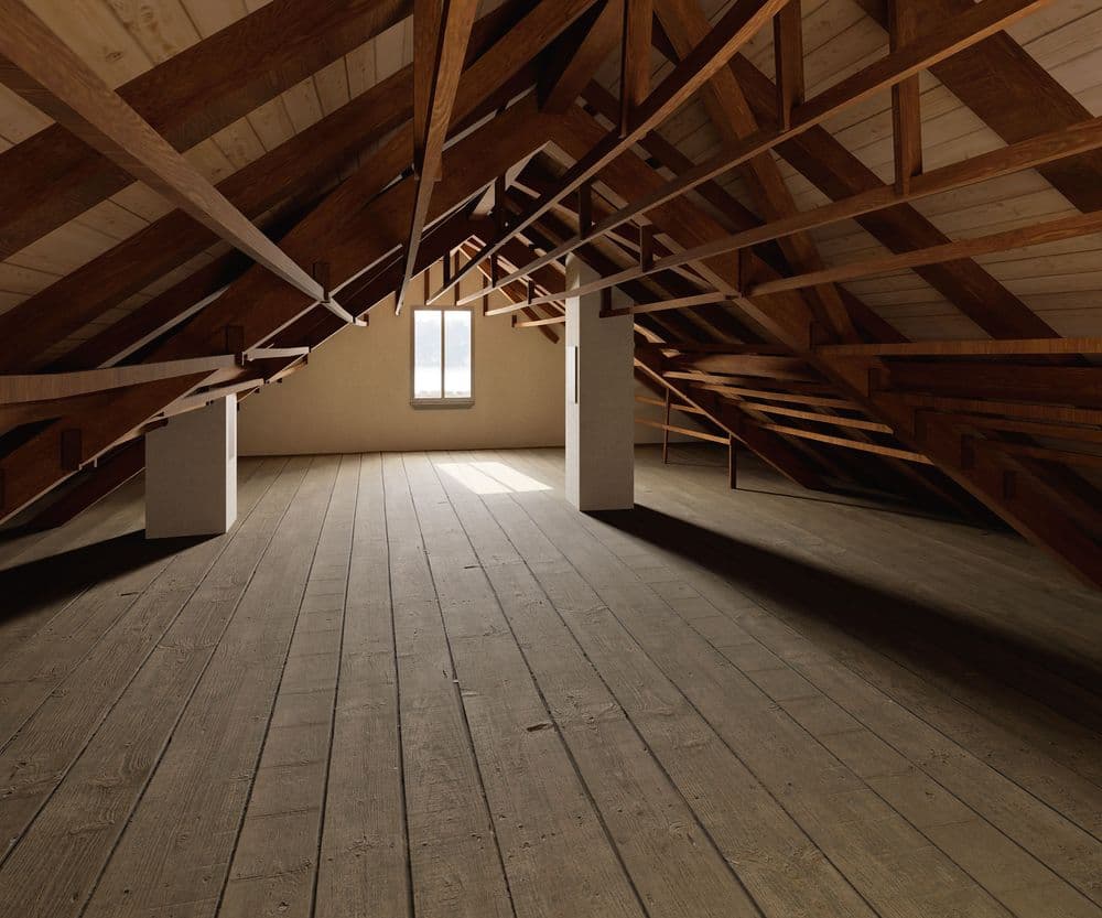 Geräumiger Dachboden mit Holzboden und sichtbaren Holzbalken, seitliches Fenster lässt Tageslicht herein.