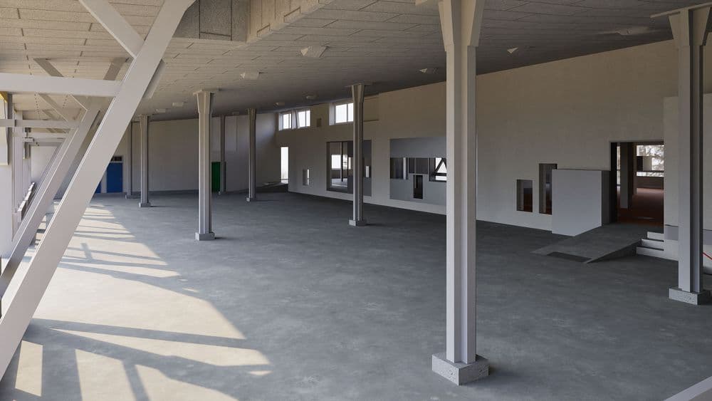 Großer leerer Innenraum mit Betonboden, Säulen und Wänden mit Fenstern und Türen.