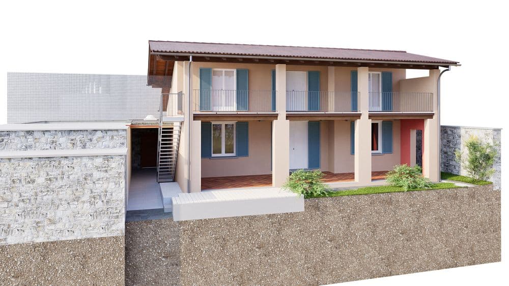 Modernisiertes, zweistöckiges Gebäude mit Terrasse und Balkon, umgeben von Steinmauer und Garten.