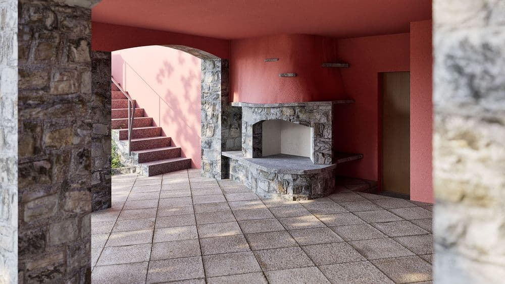 Ein Innenhof mit roten Wänden und steinernen Säulen, einer Treppe links im Hintergrund und einem Kamin.