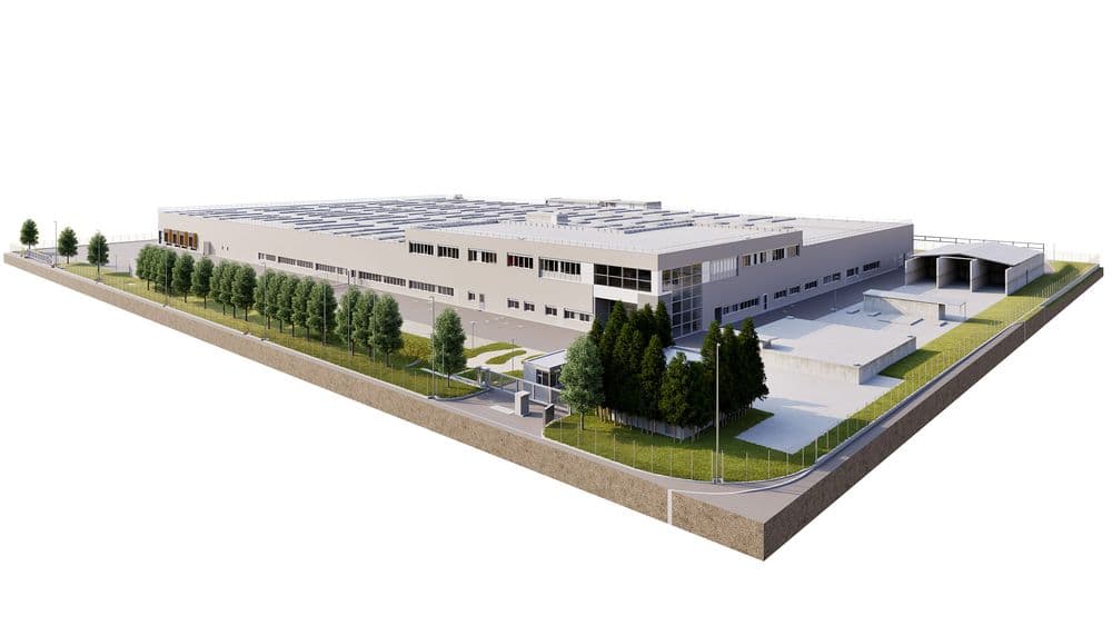 Industrielles Gebäude mit modernen Strukturen, umgeben von Grünflächen und Bäumen.