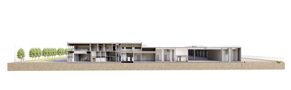 Querschnitt eines modernen Gebäudes mit viel Glas und umgeben von Bäumen.