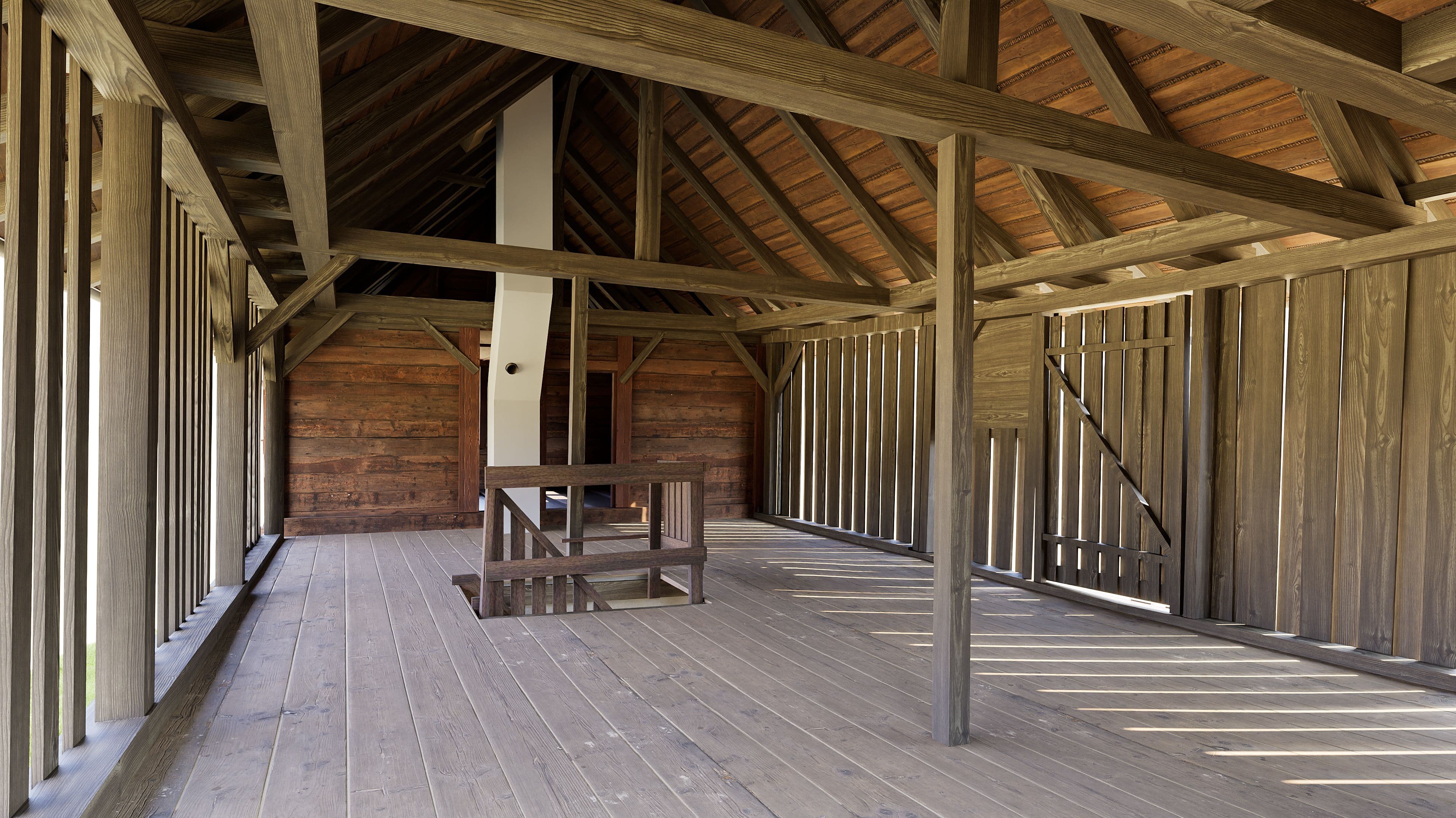 Ein leeres Holzgebäude mit offenem Innenraum, Holzbalken und Holzdielenboden.